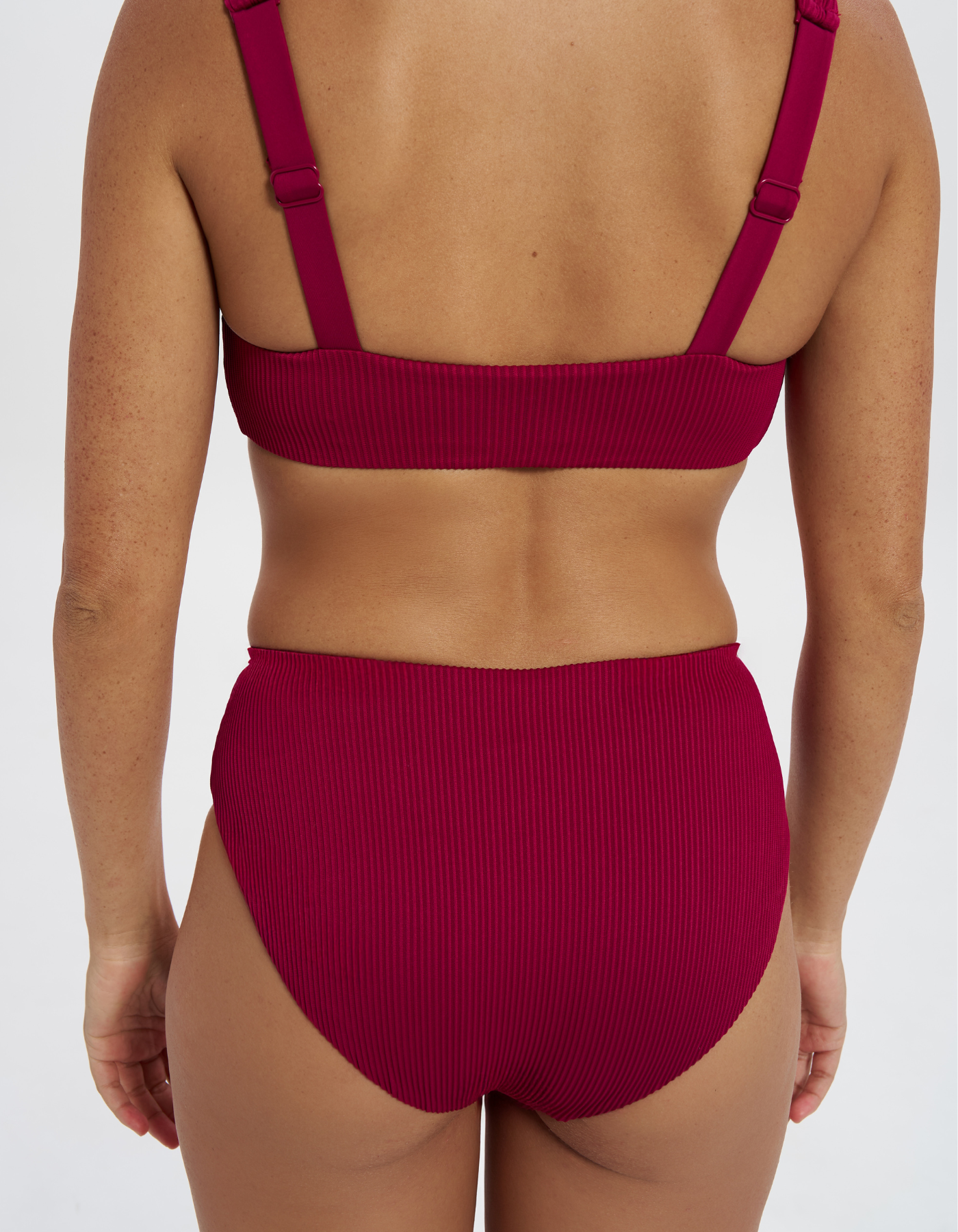 Mid Waist Plum Womens Ribbed Bikini Bottoms, back view. Sustainable womens swimwear.