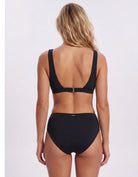 A woman shown from the back wearing a black two-piece bikini with a scoop neckline and high-waisted bottoms, photographed against a plain light gray studio background. Sandbar Swimwear