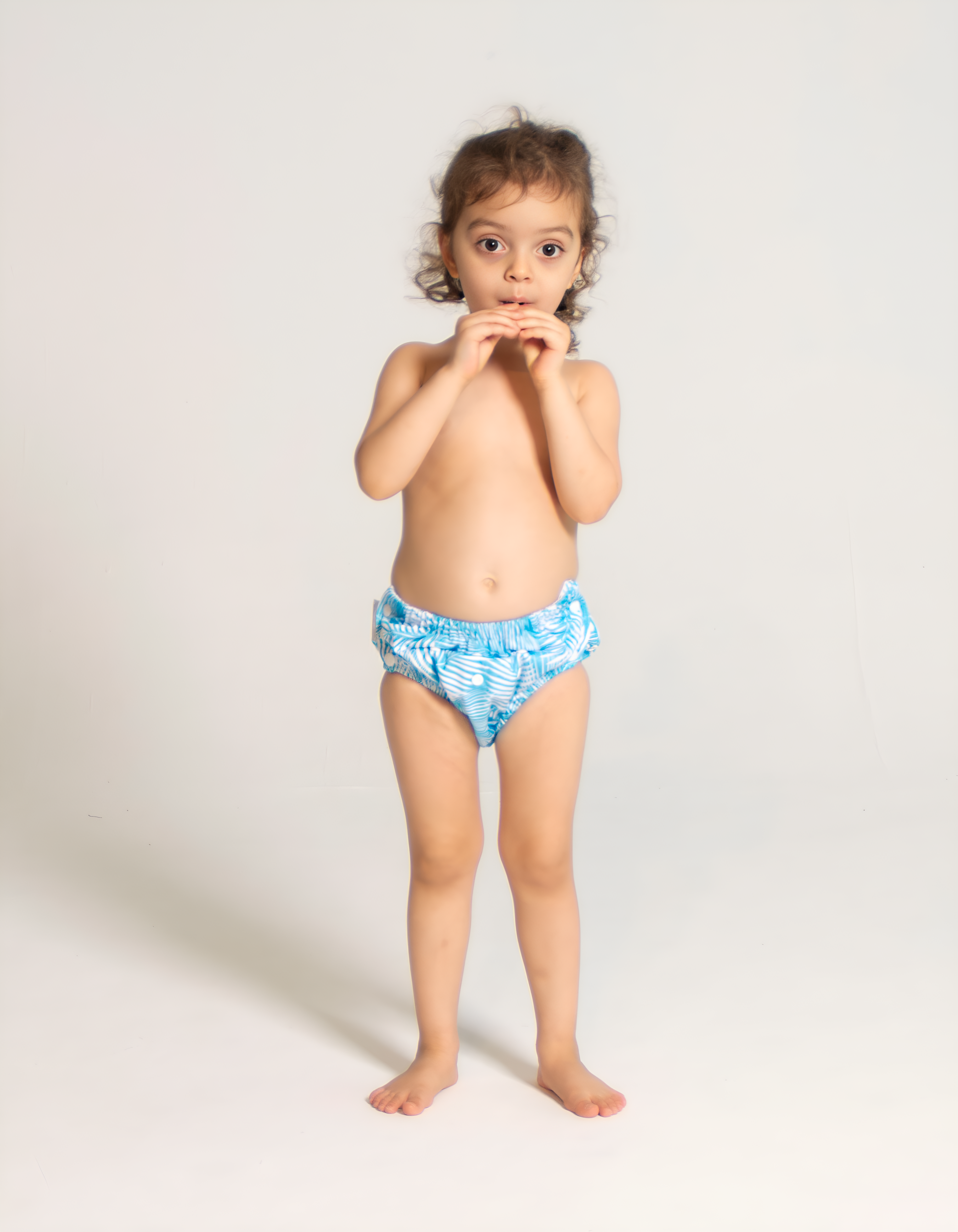 toddler girl wearing diaper under swimsuit