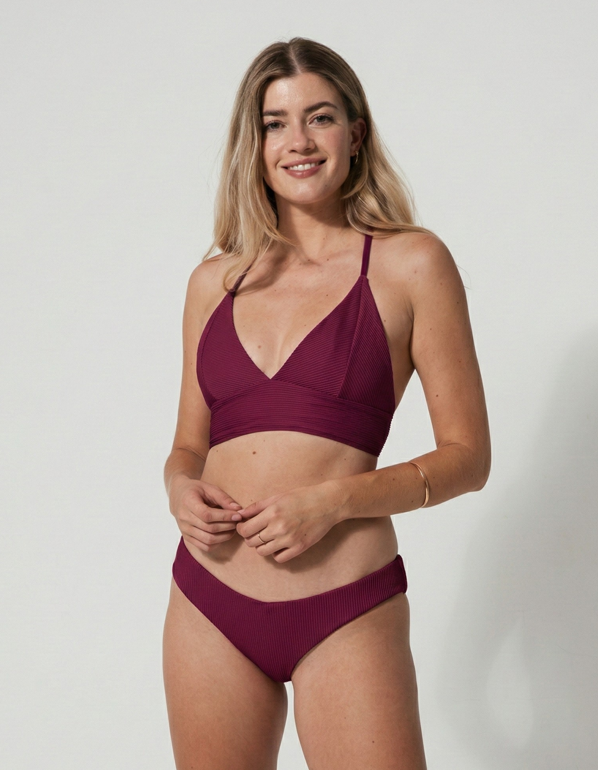 Low Waist Plum Womens Ribbed Bikini Bottoms, lifestyle shot. Sustainable womens swimwear.