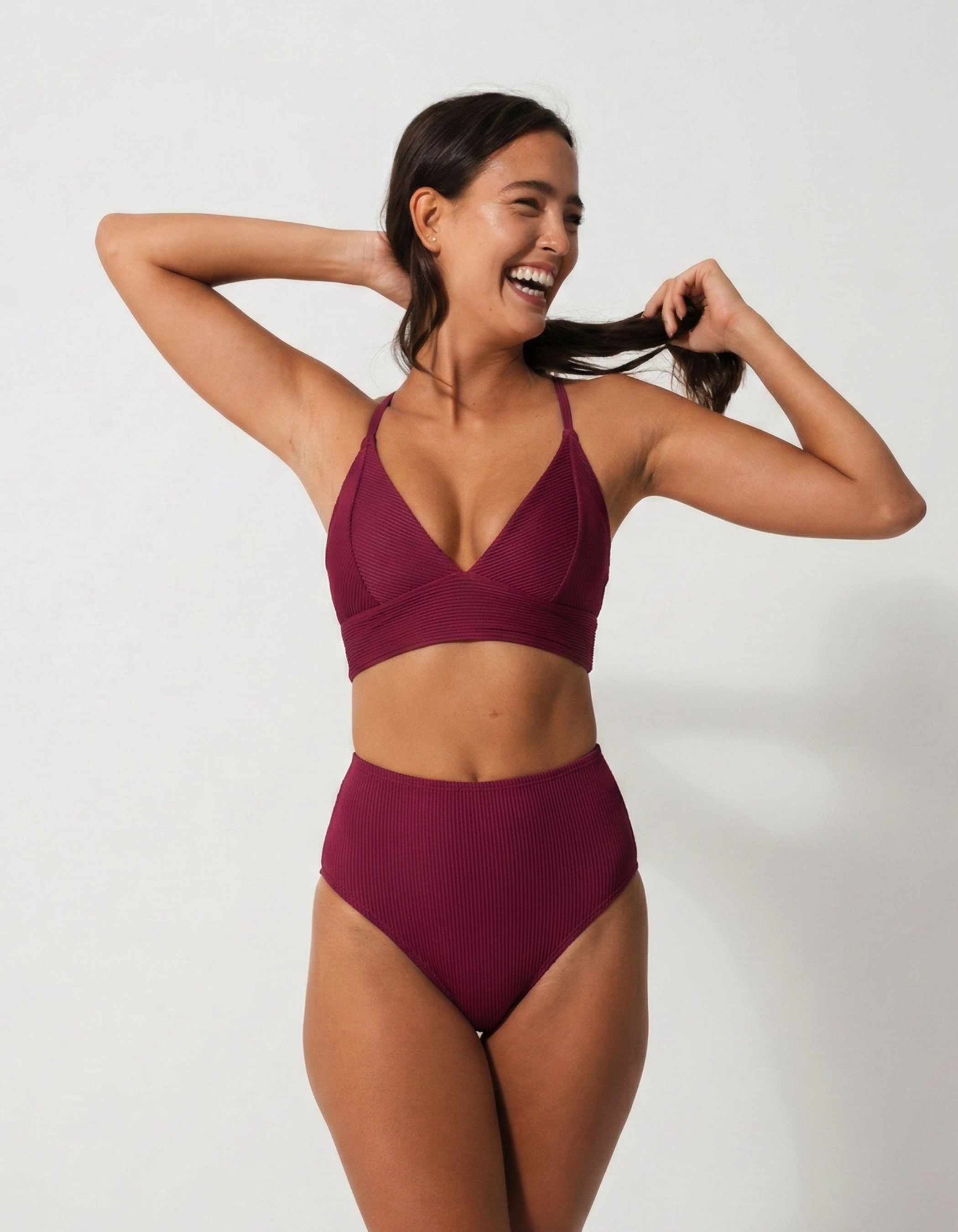 Flores Plum Womens Ribbed Plunge Bikini Top, lifestyle shot. Sustainable womens swimwear.