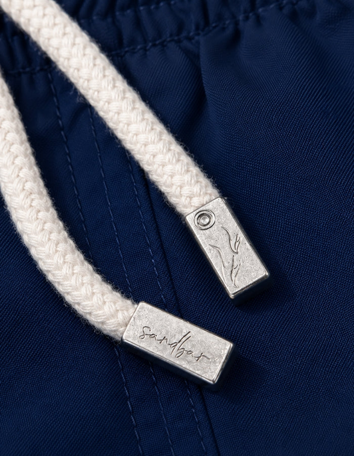 Deep Blue Boys Swim Shorts, mental string end caps. Sustainable boys swimwear.