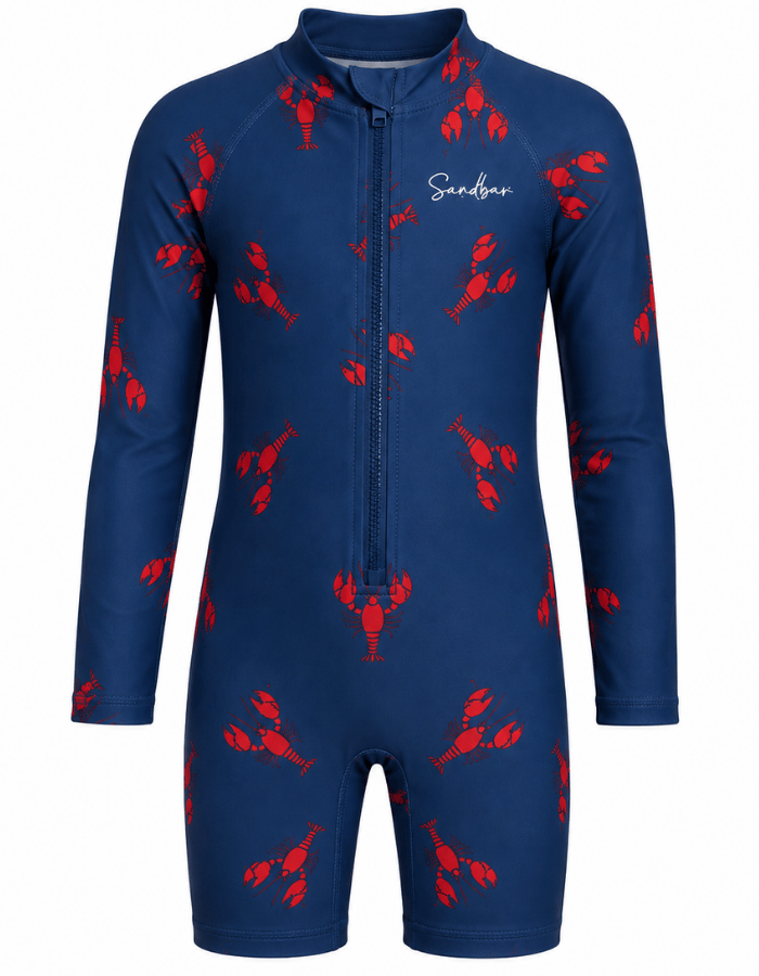 A long-sleeve, one-piece children's swim shirt in navy blue with a red lobster print pattern and a front zipper. The brand name 'Sandbar' is printed in white script on the left chest.