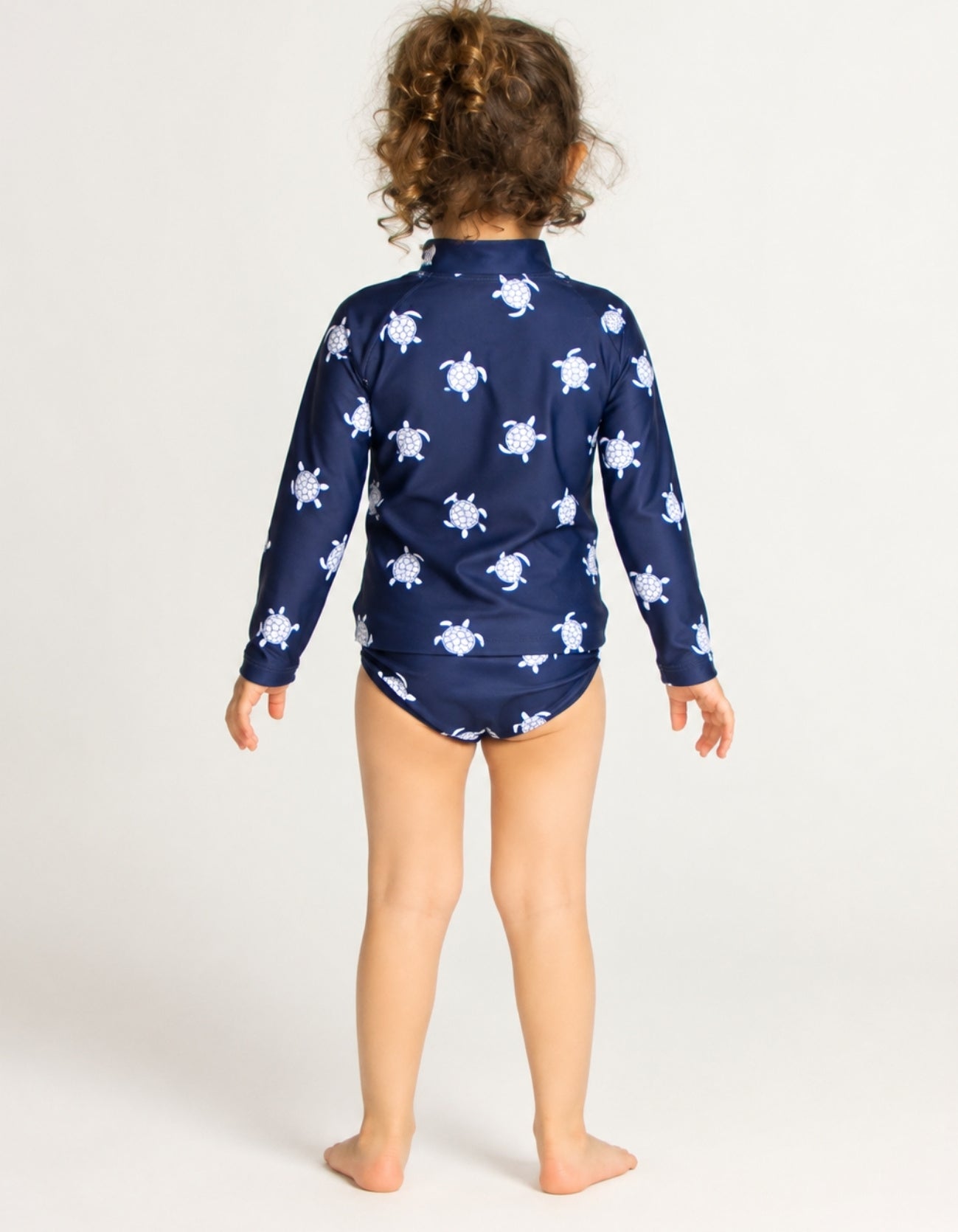Girls navy turtle print rash guard set with matching bikini bottoms, long sleeve kids UPF swimwear back view