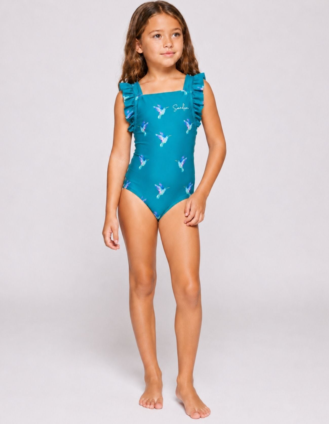 Kids teal hummingbird one-piece swimsuit with ruffle straps, front view, full
