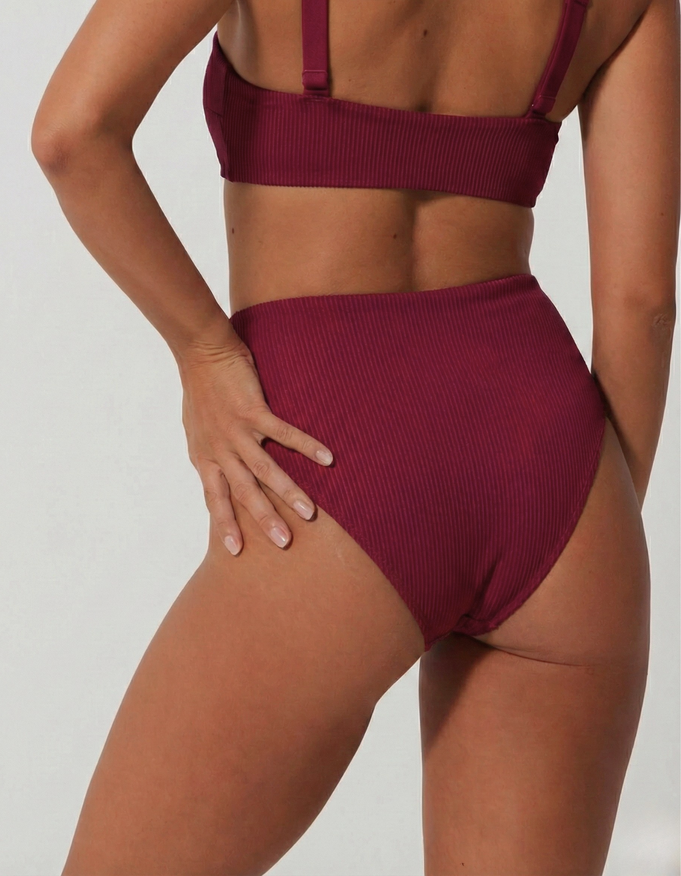 High Waist Plum Womens Ribbed Bikini Bottoms, back view. Sustainable womens swimwear.