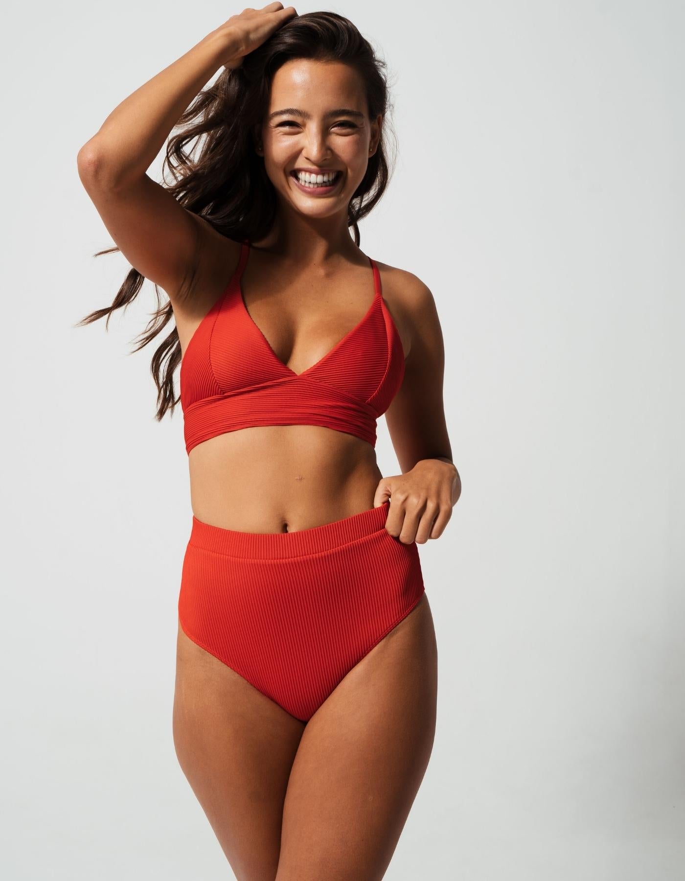 High Waist Lipstick Red Womens Ribbed Bikini Bottoms, lifestyle shot. Sustainable womens swimwear.
