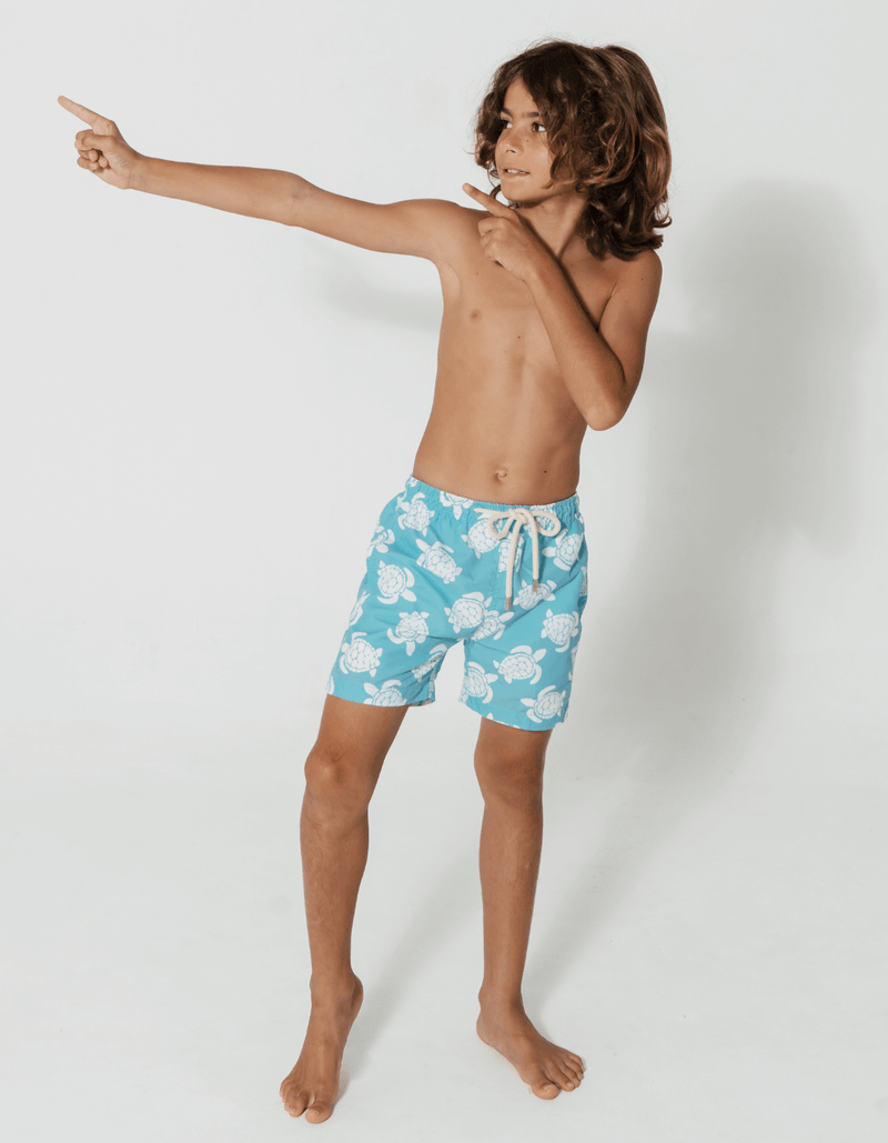 Tommy wearing Maldives Blue Turtle Boys Swim Shorts, size Age 8